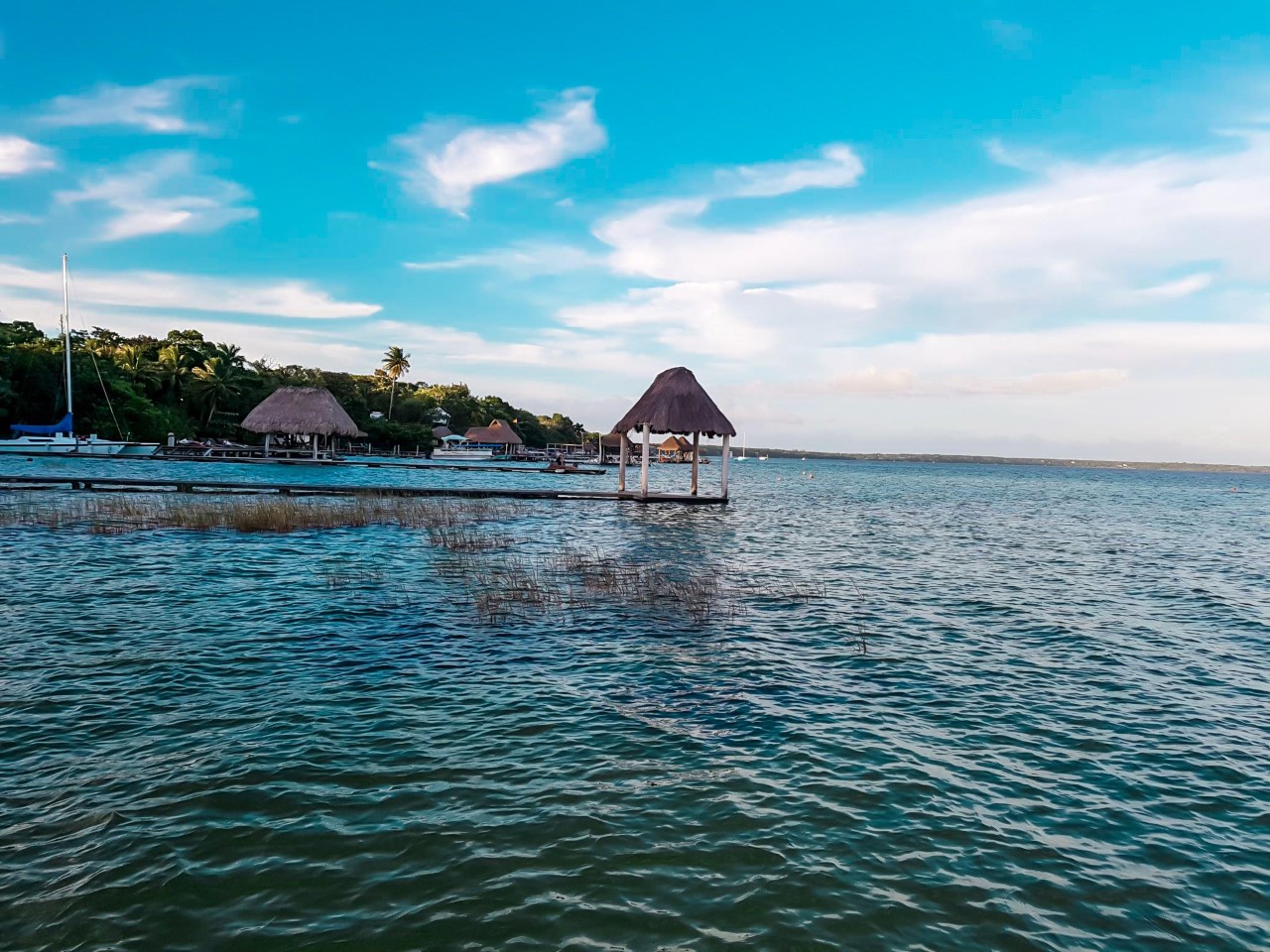 View of Bacalar lagoon with palapas in the distance